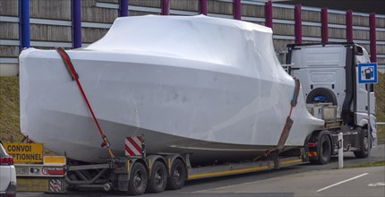 Heavy goods vehicle loaded with a yacht in a motorway car park, Mecklenburg-Vorpommern, Germany,