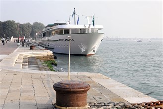 MICHELANSELO, A modern cruise ship lies on a quay while people walk by, Venice, Veneto, Italy,