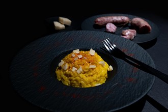 Elegant Plate with Saffron Risotto alla Milanese and Luganighe with Parmesan Cheese in Lugano,