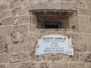 Plaque dedicated to Guiseppe Garibaldi at the Torre di Garibaldi, tower of the fortress, Alghero,
