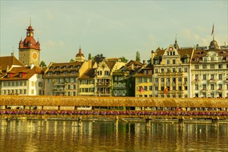 Chapel Bridge With Flowers and Luxury Hotel in City of Lucerne and Reuss River in Switzerland