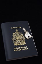 Close-up of chrome key on top of Canadian passport on black background, Studio Composition, Quebec,