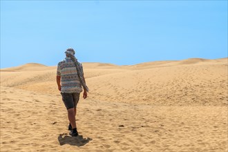 Portrait of male tourist in summer in the dunes of Maspalomas, Gran Canaria, Canary Islands