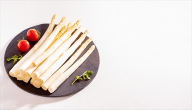 A plate of fresh white asparagus and red tomatoes on a white background, AI generated, AI generated