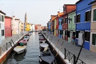 Colourful houses, Burano, Burano Island, Colourful houses line up along a quiet canal with parked