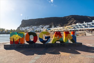 Tourist sign for the coastal town Mogan in the south of Gran Canaria. Spain
