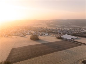 A peaceful sunrise over a village with a view of the fields, Gechingen, Black Forest, Germany,