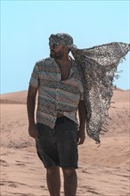Portrait of tourist man with turban in summer in the dunes of Maspalomas, Gran Canaria, Canary