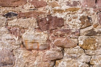 Wall made of sandstone, natural stone, quarry stone and mortar, background picture, old town,