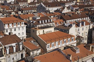 High angle view of buildings with traditional terracotta tiled rooftops in old Lisbon from Santa