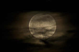 Full moon behind clouds, Braunschweig, Lower Saxony, Germany, Europe