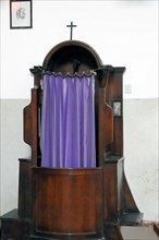 Old wooden confessional with purple curtain in a church, Venice, Veneto, Italy, Europe