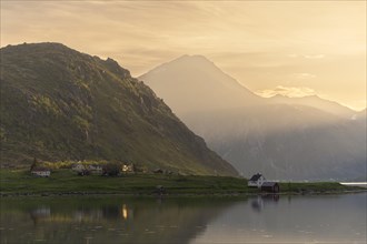 Landscape with sea and mountains on the Lofoten Islands. The fjord Flakstadpollen and some houses
