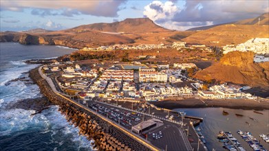 Aerial view of the town of Agaete and its Puerto de las Nieves at summer sunset in Gran Canaria.