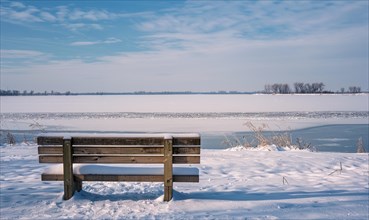 A snow-covered bench overlooking the frozen expanse of a lake AI generated