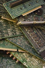 Close-up of various green electronic computer circuit boards with microchips, memory chips and hard