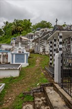 Famous cemetery, many mausoleums or large tombs decorated with tiles, often in black and white.