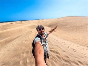 Selfie of a tourist on vacation in the dunes of Maspalomas, Gran Canaria, Canary Islands
