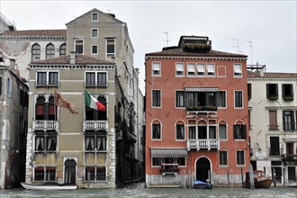 Colourful buildings on a canal, Canal Grande, in Venice with cloudy sky, Venice, Veneto, Italy,