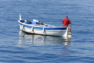 A fisherman, A calm blue sea with a small boat and a man in red, Marseille, Departement