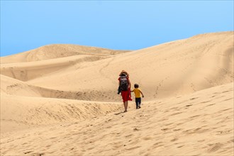 Mother and son enjoying in the dunes of Maspalomas on vacation, Gran Canaria, Canary Islands