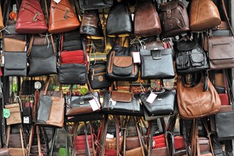 A variety of leather handbags lined up at a market stall, Venice, Veneto, Italy, Europe