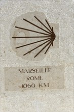 Stone wall with a signpost indicating the distance between Marseille and Rome, Marseille,