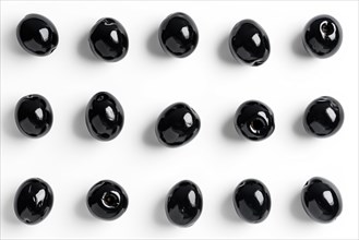 An array of glossy black spheres arranged in a grid pattern on a white background, AI generated