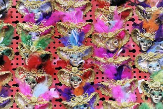 Colourful carnival masks with feather decorations present the lively celebration of the Venetian