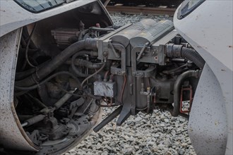 Complex machinery and hoses visible on a train engine's underside, in South Korea