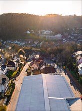 The drone image shows a street in a residential area during sunset, Calw, Black Forest, Germany,