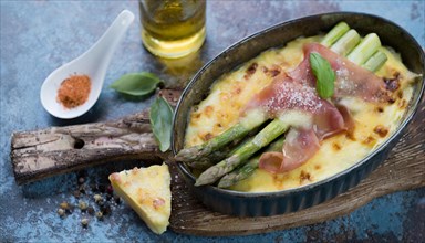 Baked asparagus with ham and cheese served in a casserole dish, asparagus casserole with green