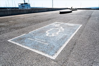 Parking space for an electric car on the beach in Barcelona, Spain, Europe
