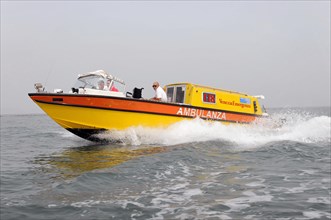 AMBULANZA, A yellow lifeboat races across the sea while making waves, Venice, Veneto, Italy, Europe