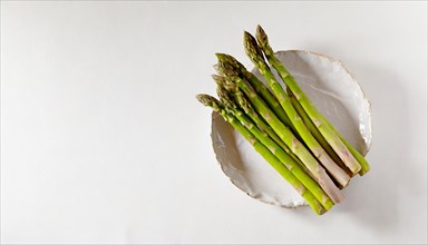 Green asparagus on a white plate with a clean background, AI generated, AI generated