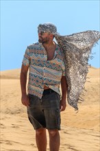 Portrait of tourist man with turban in summer in the dunes of Maspalomas, Gran Canaria, Canary