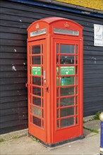 Red former telephone box, harbour, Folkestone, Kent, Great Britain