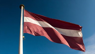 Flags, the national flag of Latvia flutters in the wind
