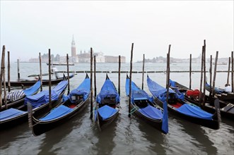 Several gondolas moored with a view of historic Venetian architecture, Venice, Veneto, Italy,