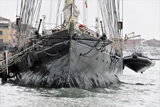 Black sailing ship with several masts on moving water, Venice, Veneto, Italy, Europe