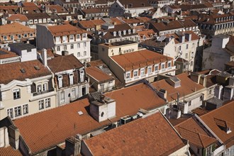 High angle view of buildings with traditional terracotta tiled rooftops in old Lisbon from Santa