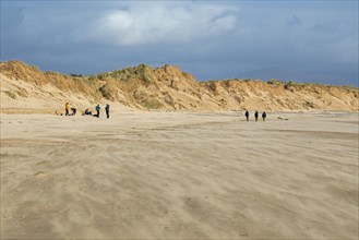 Sand blowing over beach, people, clouds, LLanddwyn Bay, Newborough, Isle of Anglesey, Wales, Great