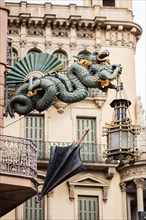 A dragon holds a lantern on the facade of a house on the Ramblas in Barcelona, Spain, Europe