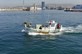 Marseille, A fishing boat in motion on the sea, near a harbour, Marseille, Departement