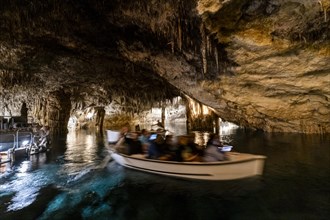 People in the boat on lake in amazing Drach Caves in Mallorca, Spain, Europe
