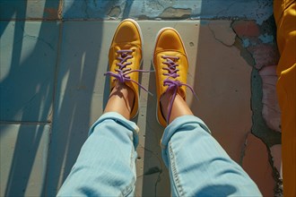 Looking down at yellow sneakers, a personal perspective with blue jeans and textured ground, AI