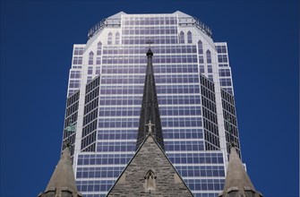 Old Christ Church Cathedral facade with spire and modern architectural steel and blue tinted glass