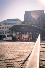 Modern bus station with kiosk in town, sunrise, Nagold, Black Forest, Germany, Europe