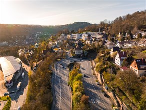 View of a busy intersection in the glowing evening light with hospital, Calw, Black Forest,