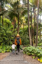 A woman with her son walking in a botanical garden. Walking with family